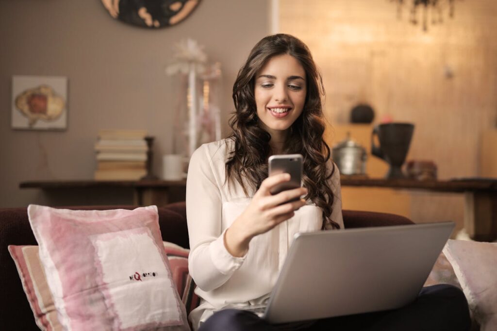 Woman Sitting on Sofa While Looking at phone in Videocall with meeteasily user